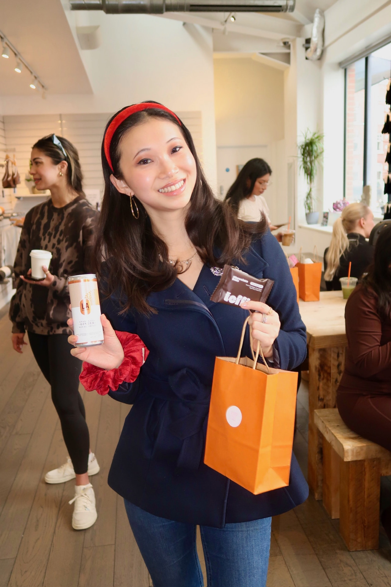 Member holding a goody bag at a Women's Wellness Club event